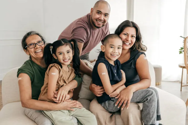 Portrait photo of a family with bandaids on their arms