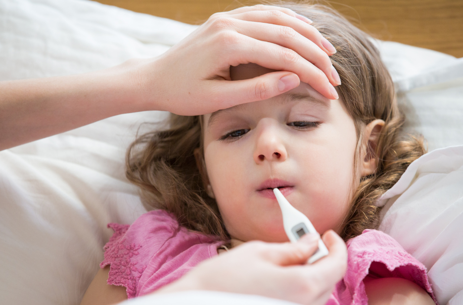 A young girl getting her temperature taken.